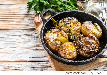 Jacket baked potato with garlic and rosemary in a 72965273