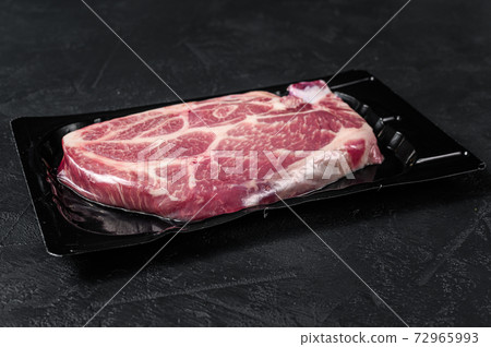 Unopened vacuum pack of pork steak isolated on 72965993
