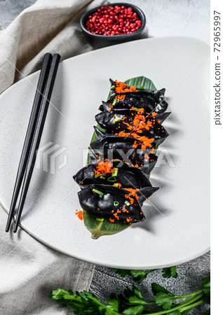 Steamed dumplings Dim Sum in bamboo steamer. Gray 72965997