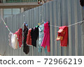 laundry drying on metal fence 72966219