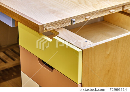 Plywood desk with multi color drawers during assembly. Close-up 72966314