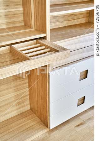 Modern wardrobe with slide out rack for coathangers. Detail of modern furniture 72966709