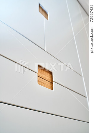 Modern wardrobe with finger pull design. Wooden wardrobe with light gray cabinet doors. Modern furniture Modern wardrobe with finger pull design. Wooden wardrobe with light gray cabinet doors. Modern furniture 72967422