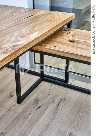 Live edge elm desk with metal base in a modern home office. Fragment of the desk 72967476