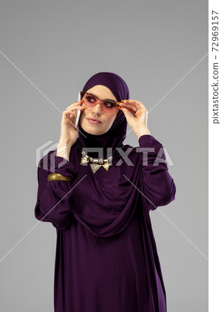 Beautiful arab woman posing in stylish hijab isolated on studio background. Fashion concept 72969157