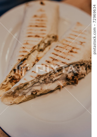 shawarma burito kebab with juicy sauce filling wrapped in grilled pita bread shawarma burito kebab with juicy sauce filling wrapped in grilled pita bread 72969634