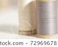 Thread closeup on white fabric 72969678