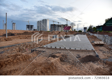 Laying paving slabs and borders at construction site. Laying paving slabs and borders at construction site. 72969818