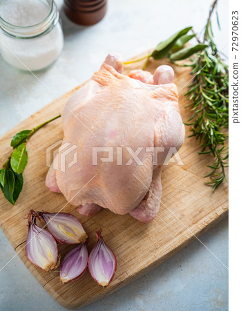 Raw chicken with rosemary and herbs - ready for cooking Raw chicken with rosemary and herbs - ready for cooking 72970623