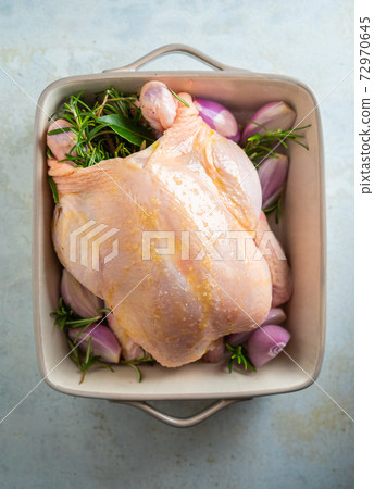 Raw chicken with rosemary and herbs - ready for cooking Raw chicken with rosemary and herbs - ready for cooking 72970645