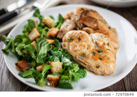 Delicious caesar salad with homemade croutons and dressing. Delicious caesar salad with homemade croutons and dressing. 72970649