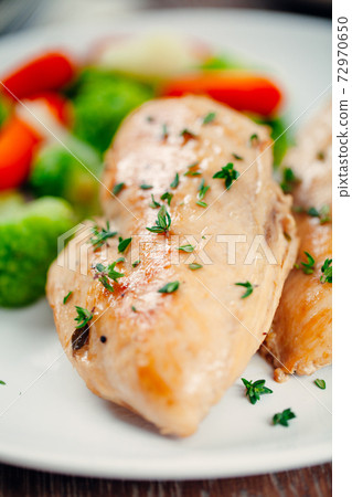 Grilled chicken breast with mixed vegetables on a plate 72970650