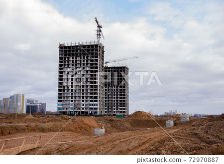 Tower cranes constructing new residential buildings at construction site.  72970887