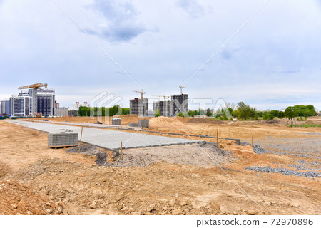 Laying paving slabs and borders at construction site. Laying paving slabs and borders at construction site. 72970896