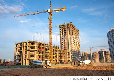 Heavy mixer concrete truck for to be loaded concrete at a construction site. Heavy mixer concrete truck for to be loaded concrete at a construction site. 72970911