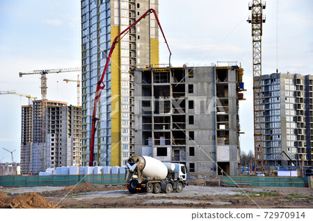 Heavy mixer concrete truck for to be loaded concrete at a construction site. Heavy mixer concrete truck for to be loaded concrete at a construction site. 72970914