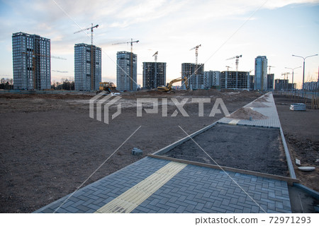 Laying paving slabs and borders at construction site. Laying paving slabs and borders at construction site. 72971293