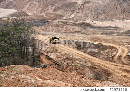 Mining truck transportion minerals and sand in the open-pit. Heavy machinery  72971316
