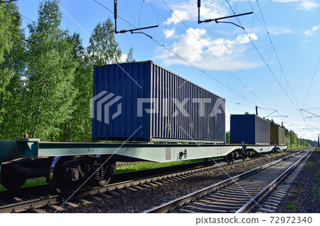 Cargo Containers Transportation On Freight Train By Railway. Intermodal Container On Train Car. Cargo Containers Transportation On Freight Train By Railway. Intermodal Container On Train Car. 72972340