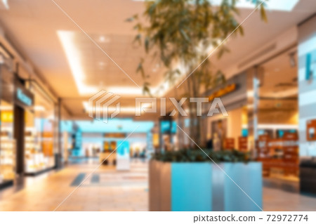 Shopping mall interior blurred background. People shopping in modern commercial mall center. Interior of retail centre store in soft focus. Image for background use. Shopping mall interior blurred background. People shopping in modern commercial mall center. Interior of retail centre store in soft focus. Image for background use. 72972774