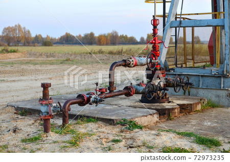 Industrial piping with steel flanges and bolts on oil field. Industrial piping with steel flanges and bolts on oil field. 72973235