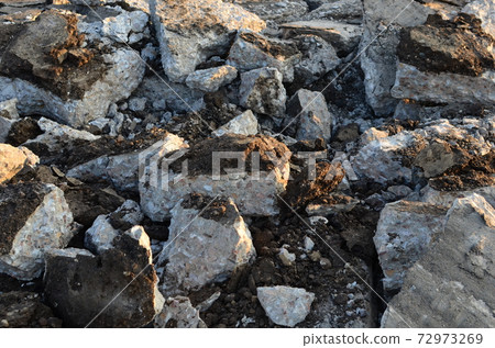 Broken pieces of asphalt at a construction site. Broken pieces of asphalt at a construction site. 72973269