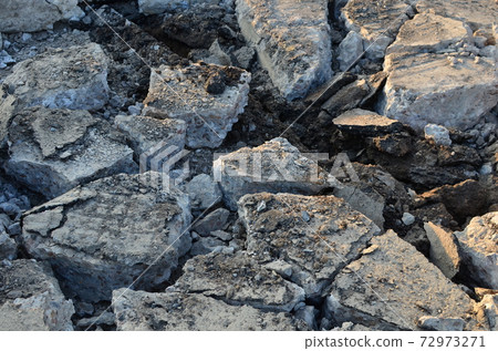 Broken pieces of asphalt at a construction site. Broken pieces of asphalt at a construction site. 72973271