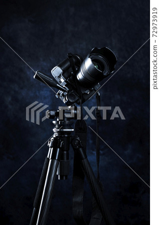 Single-lens reflex camera attached to a tripod Single-lens reflex camera attached to a tripod 72973919