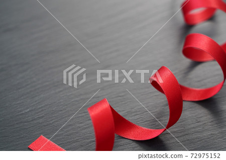 Red ribbon on black background 72975152