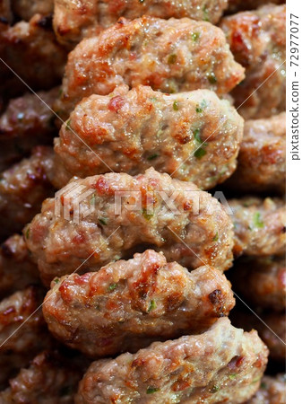 Hamburger steak made with a mixture of beef and vegetables Hamburger steak made with a mixture of beef and vegetables 72977077