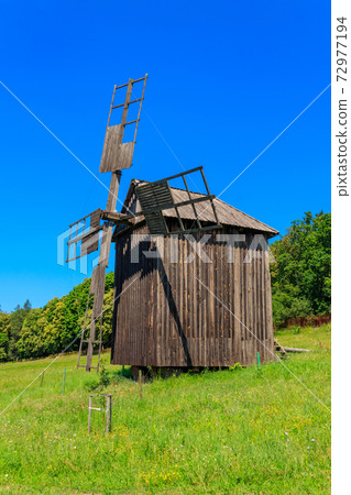 Old wooden windmill in Pyrohiv (Pirogovo) village near Kiev, Ukraine Old wooden windmill in Pyrohiv (Pirogovo) village near Kiev, Ukraine 72977194