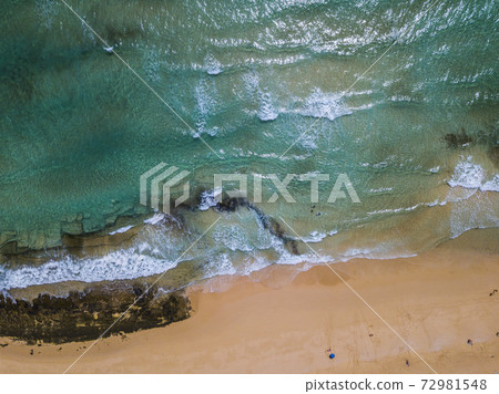 Vertical view of blue clean sea water and yellow sandy beach - concept of tropical scenic place.and summer holiday vacation - tourism and tourists people 72981548
