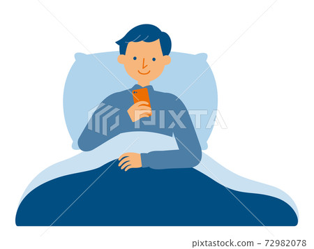 A man who operates a smartphone in a futon 72982078