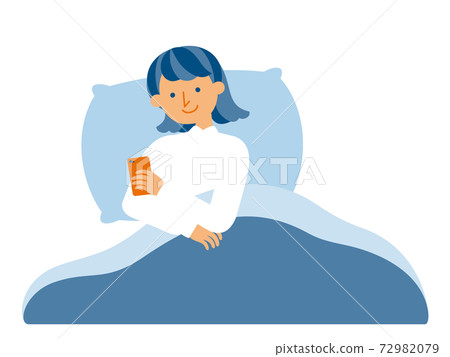 A woman who operates a smartphone in a futon A woman who operates a smartphone in a futon 72982079