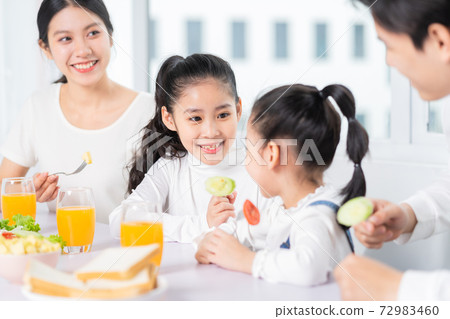 Family eating breakfast 72983460