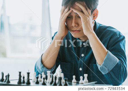 Man playing chess Man playing chess 72983534
