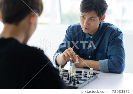 Man playing chess 72983571