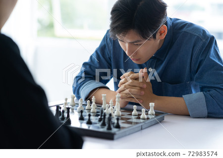 Man playing chess 72983574