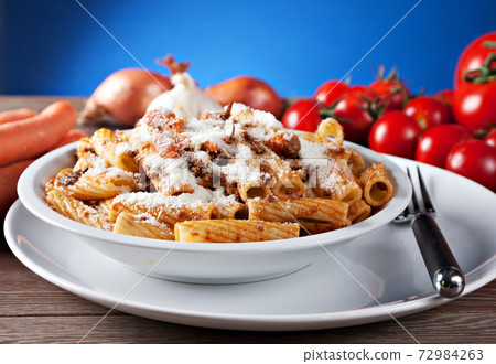 Macaroni Bolognese on a plate. Typical Italian dish. Macaroni Bolognese on a plate. Typical Italian dish. 72984263
