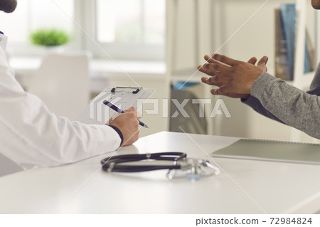 Patient telling doctor about his symptoms and asking to prescribe him some medicine 72984824