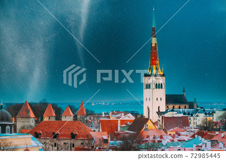 Tallinn, Estonia. Night Starry Sky Above Traditional Old Architecture Skyline In Old Town. Church Of St. Olaf Or Olav In Winter Evening Night. Famous Landmark. Altered Sky With Stars. UNESCO Heritage Tallinn, Estonia. Night Starry Sky Above Traditional Old Architecture Skyline In Old Town. Church Of St. Olaf Or Olav In Winter Evening Night. Famous Landmark. Altered Sky With Stars. UNESCO Heritage 72985445