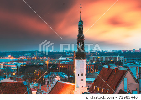 Tallinn, Estonia. Night Sunset Sky Above Traditional Old Architecture Skyline In Old Town. Church Of Holy Ghost Or Holy Spirit In Winter Evening. Famous Landmark And UNESCO Heritage Site. Altered Sky 72985446