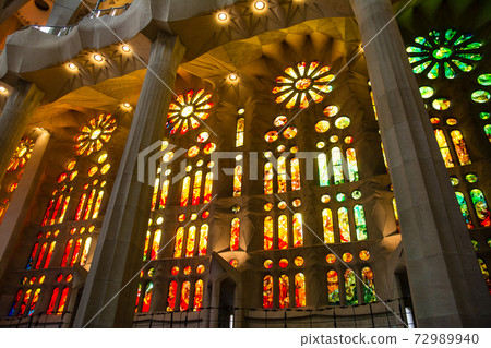 Inside the Sagrada Familia in Barcelona, Spain, colorful stained glass and unusually designed interior 72989940
