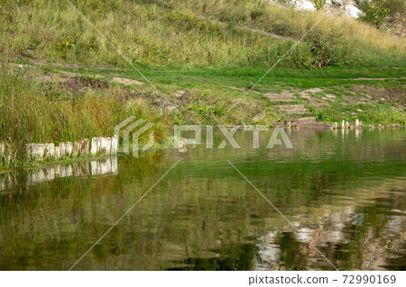 Deep water surface shore lake or river. Serene coastal landscape Deep water surface shore lake or river. Serene coastal landscape 72990169