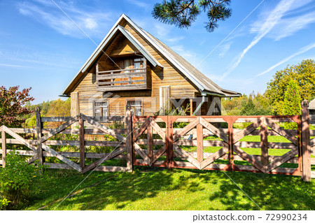 Rural wooden house in russian village 72990234