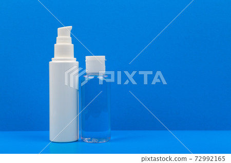Face cream and lotion on blue table against blue background. Concept of hygiene and skincare with copy space Face cream and lotion on blue table against blue background. Concept of hygiene and skincare with copy space 72992165