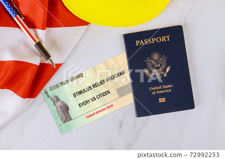 Stimulus relief check Passport of USA on American flag About Form 7200, Advance Payment of Employer Credits Due to COVID-19 72992253
