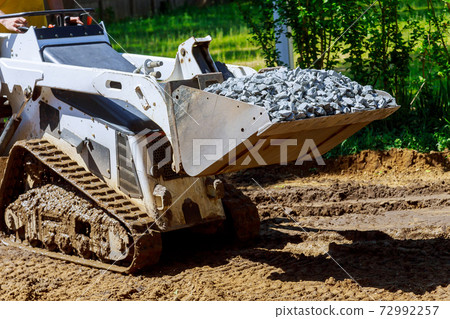 The bulldozer moves gravel stones construction equipment The bulldozer moves gravel stones construction equipment 72992257