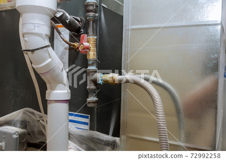 installation of heating system on the pipe system of heating closeup installation of heating system on the pipe system of heating closeup 72992258