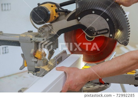 Close up of Circular saw cutting sharp rotary blade new baseboard woodwork Close up of Circular saw cutting sharp rotary blade new baseboard woodwork 72992285